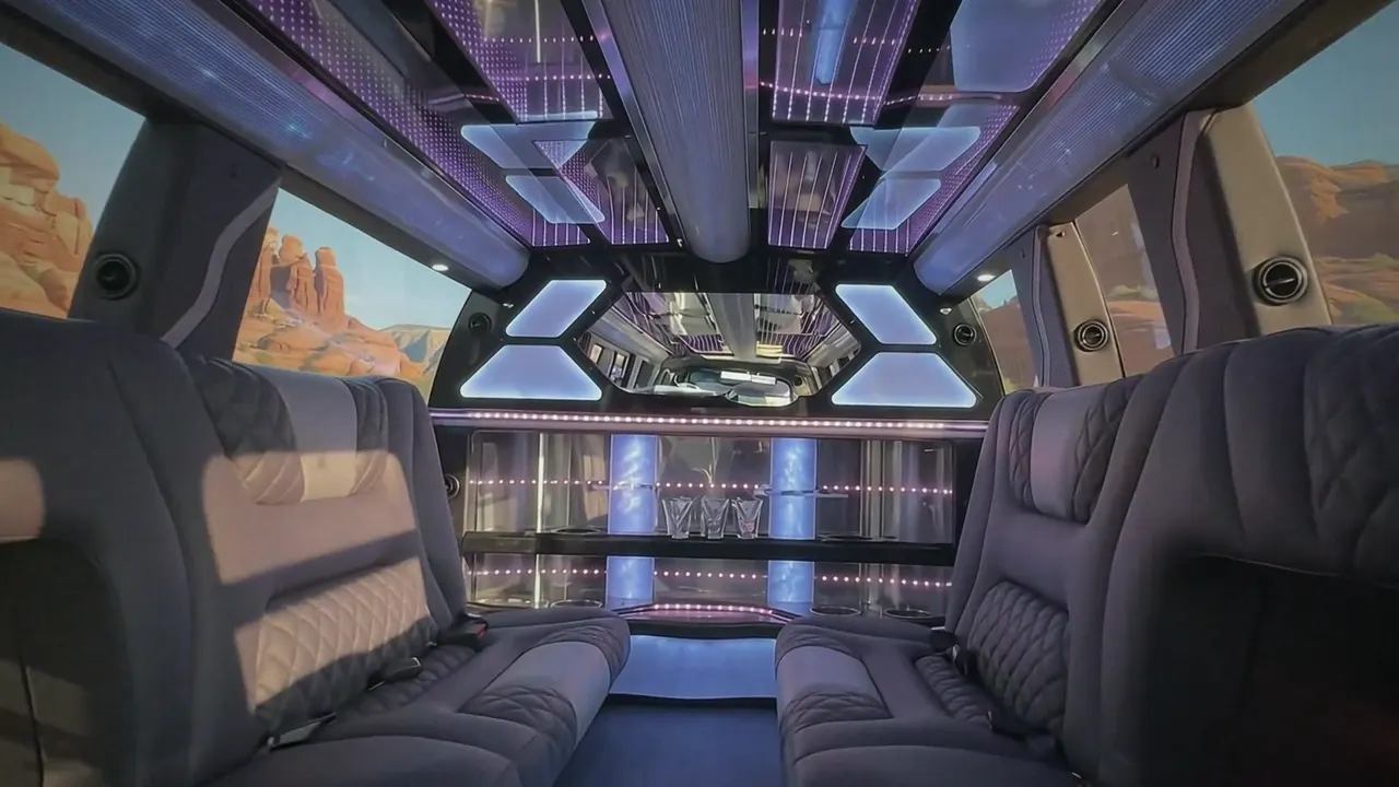 Inside the Cadillac Escalade limo in Berthoud: LED light-show ceiling, leather lounge seating and lit bar